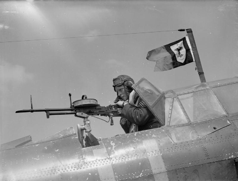 A sergeant air-gunner mans his Vickers 'K' gun...